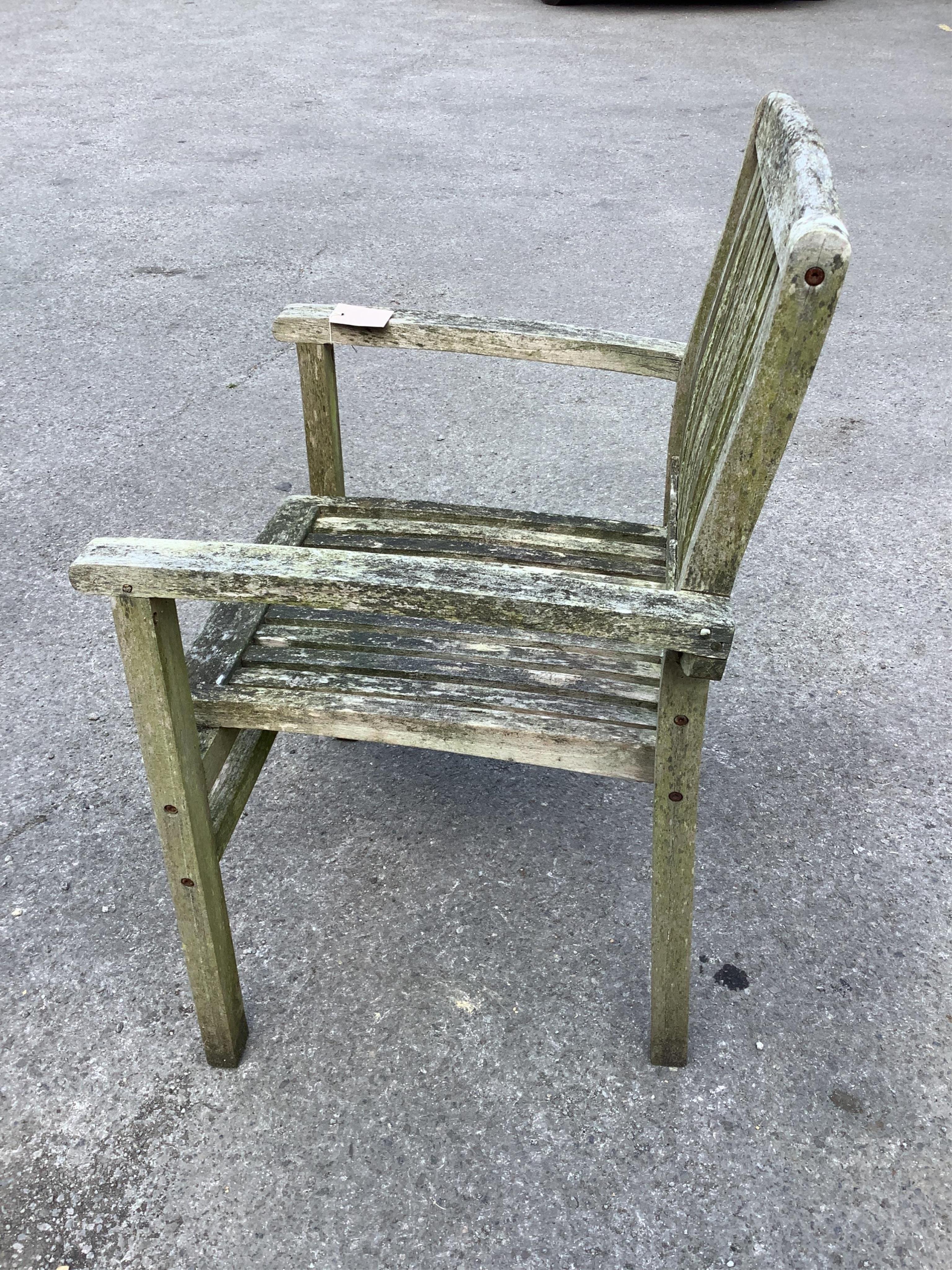 A “Kyoto” weathered teak extending garden table, width 240cm extended, depth 100cm, height 75cm, together with six stacking elbow chairs. Condition - fair
